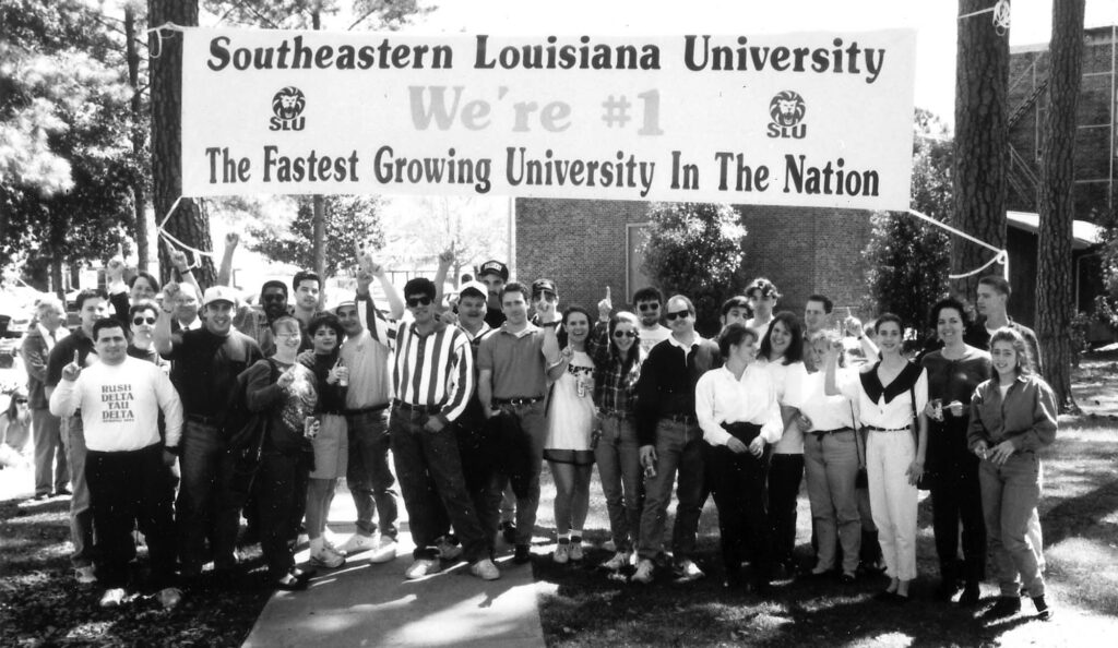 Students gather with a sign stating that Southeastern is the fastest growing university in the nation.